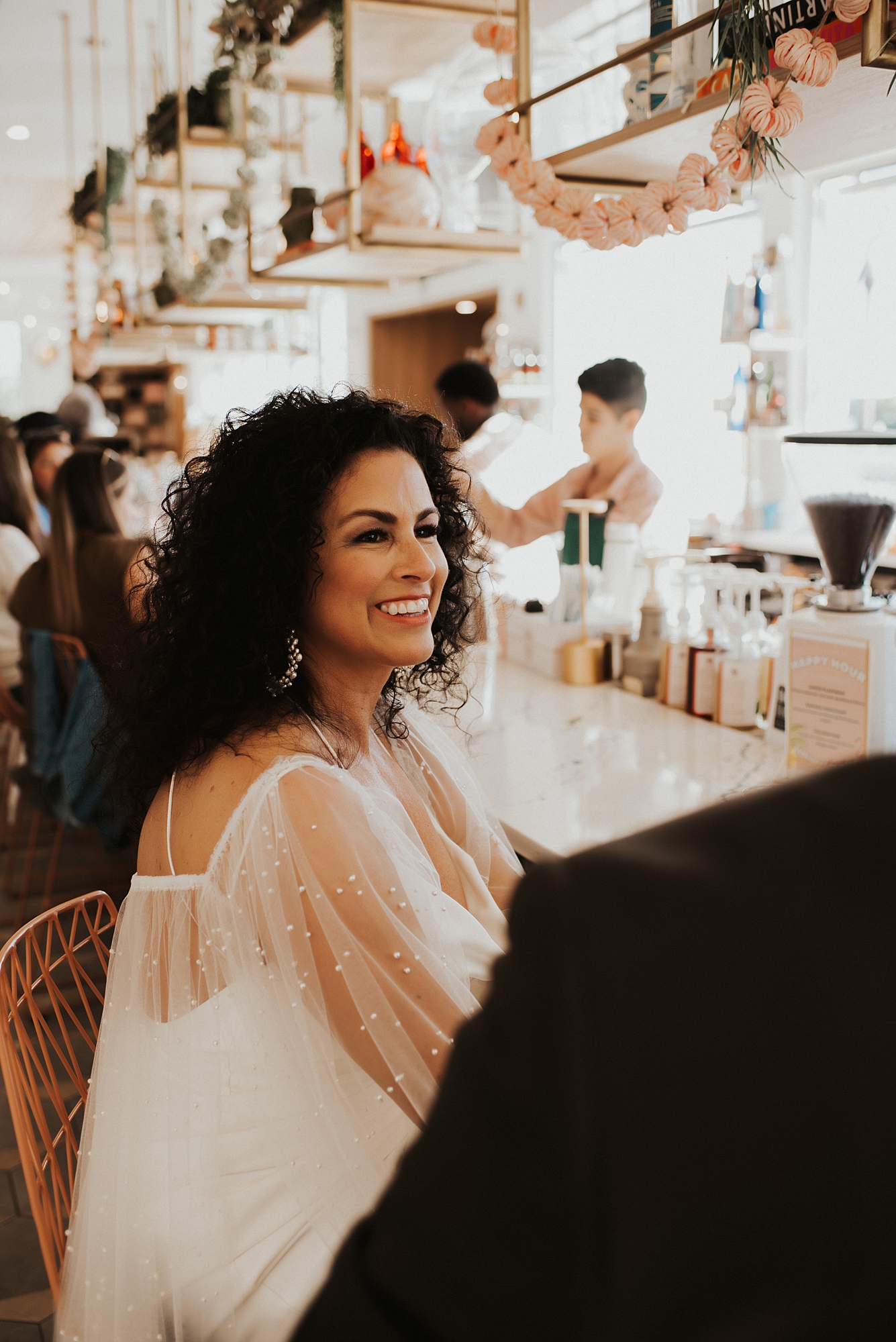 Bride sitting at bar of Fonville Press in Rosemary Beach