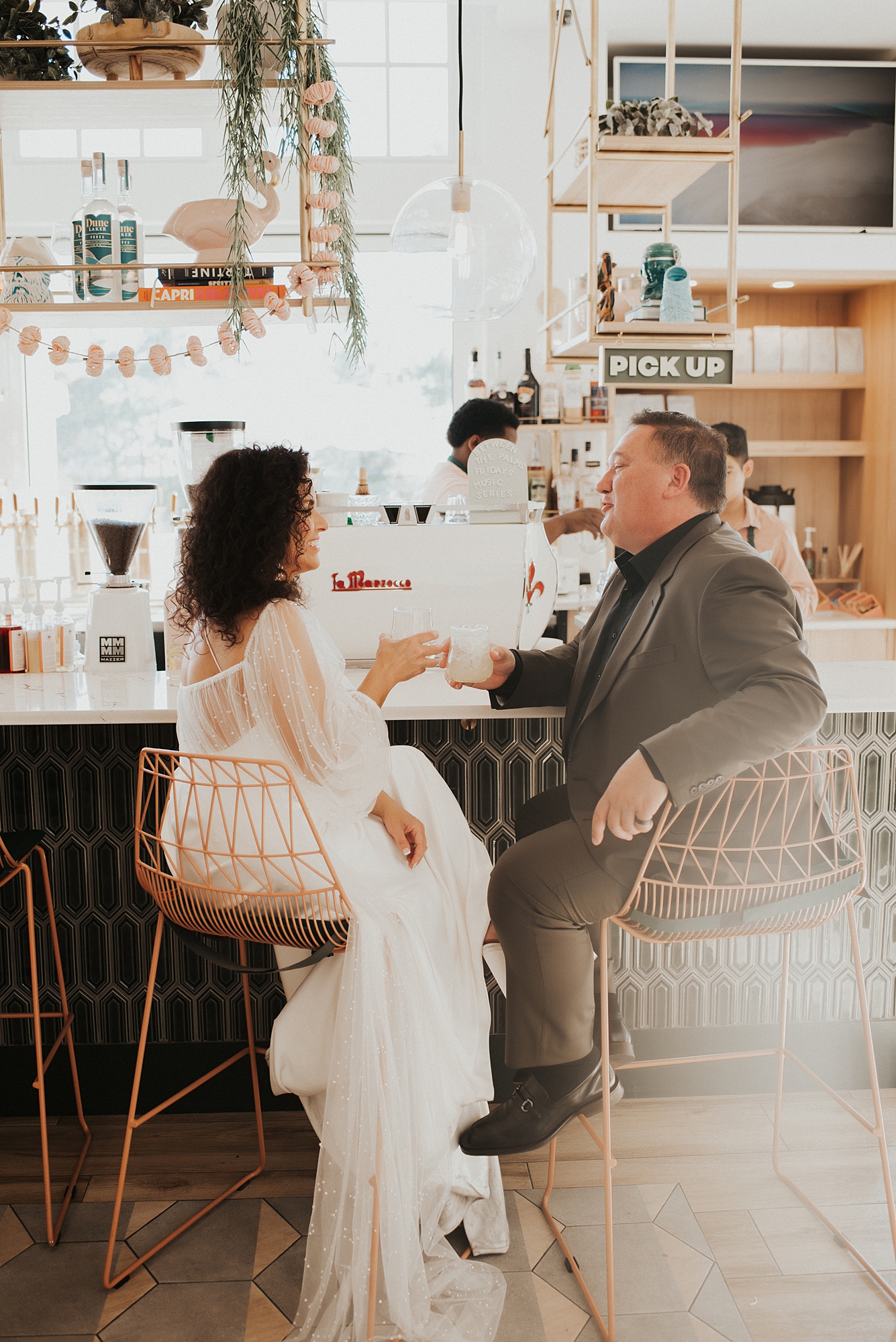 Bride and groom sitting at bar of Fonville Press in Rosemary Beach