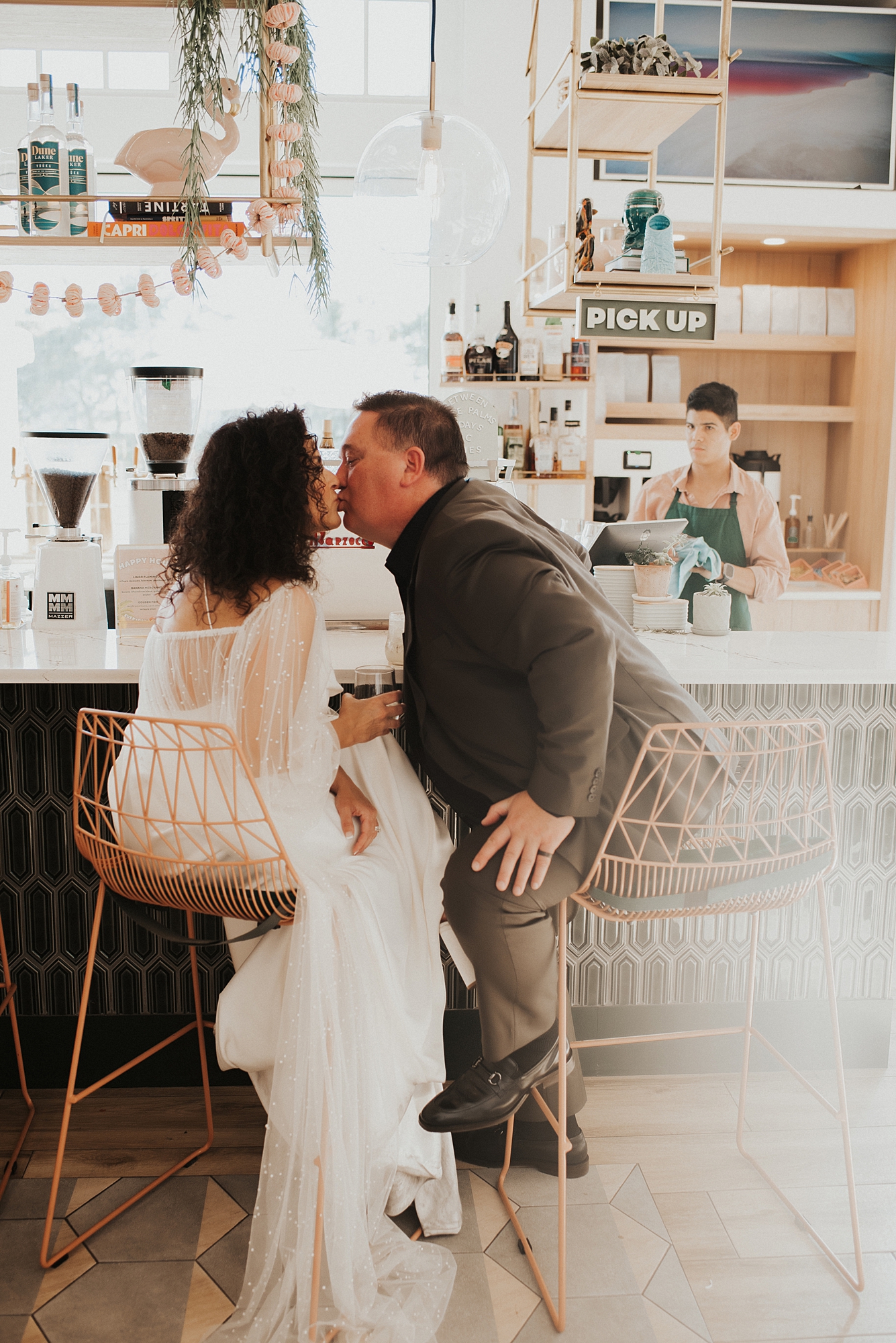 Bride and groom sitting at bar of Fonville Press in Rosemary Beach