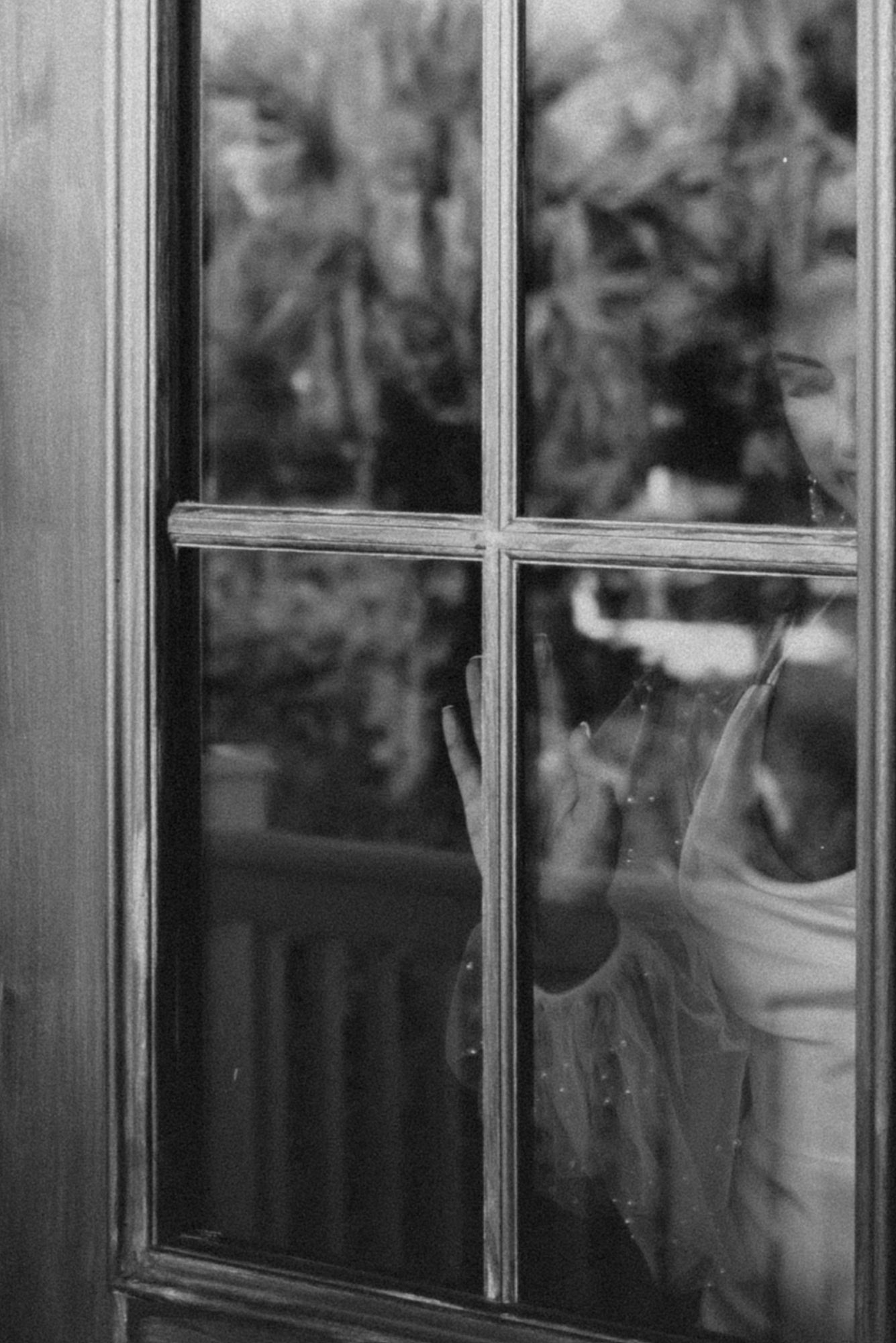 Bride walking through door for first look with groom